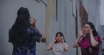 Movie still from “Amanda Sum - Groupthink” (2020), directed by Mayumi Yoshida – Medium shot, Low angle