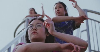 Movie still from “Amanda Sum - Groupthink” (2020), directed by Mayumi Yoshida – Medium shot, Low angle