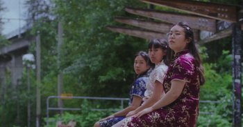 Movie still from “Amanda Sum - Groupthink” (2020), directed by Mayumi Yoshida – Medium shot, Low angle