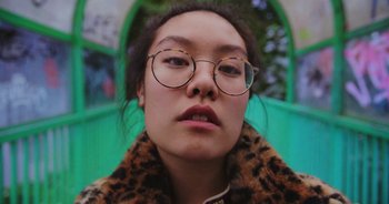 Movie still from “Amanda Sum - Groupthink” (2020), directed by Mayumi Yoshida – Close Up shot, Low angle