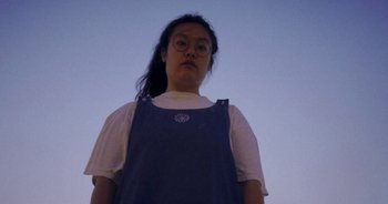 Movie still from “Amanda Sum - Groupthink” (2020), directed by Mayumi Yoshida – Medium shot, Low angle