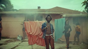 Movie still from “SAINt JHN - Roses (Remix) feat. Future” (2020), directed by John Tashiro – Medium shot, Low angle