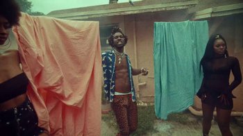 Movie still from “SAINt JHN - Roses (Remix) feat. Future” (2020), directed by John Tashiro – Medium shot, Low angle