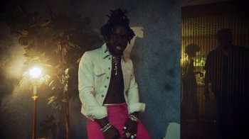 Movie still from “SAINt JHN - Roses (Remix) feat. Future” (2020), directed by John Tashiro – Medium shot, Low angle