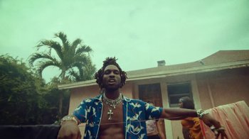 Movie still from “SAINt JHN - Roses (Remix) feat. Future” (2020), directed by John Tashiro – Medium shot, Low angle