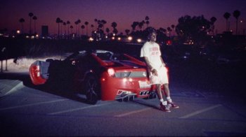 Movie still from “SAINt JHN - Roses (Remix) feat. Future” (2020), directed by John Tashiro – Wide shot, Low angle