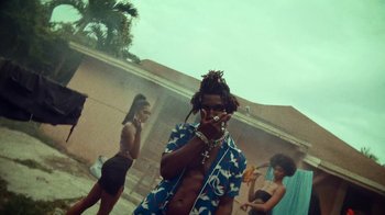 Movie still from “SAINt JHN - Roses (Remix) feat. Future” (2020), directed by John Tashiro – Medium shot, Low angle