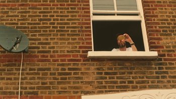 Movie still from “Glass Animals - Heat Waves” (2020), directed by Colin Read – Medium shot, Low angle