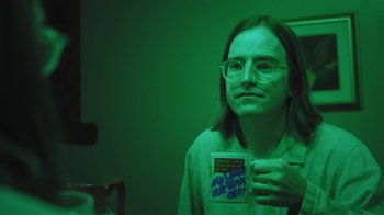 Movie still from “Dent May - I Could Use A Miracle” (2020), directed by Nathan Castiel – Close Up shot, High angle