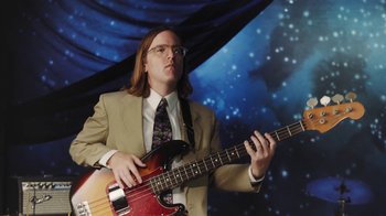Movie still from “Dent May - I Could Use A Miracle” (2020), directed by Nathan Castiel – Medium shot, Low angle