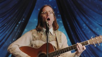 Movie still from “Dent May - I Could Use A Miracle” (2020), directed by Nathan Castiel – Medium shot, Low angle