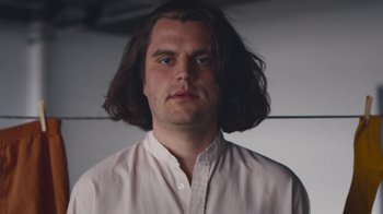 Movie still from “Alex Nicol - Trust” (2020), directed by Paz Ramirez – Close Up shot, Low angle