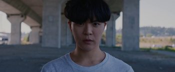 Movie still from “Kiccc - Here” (2019), directed by Riun Garner – Close Up shot, Low angle