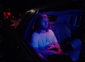 Movie still from “Ali Gatie - It’s You” (2019), directed by Nathan R. Smith – Medium shot, Low angle