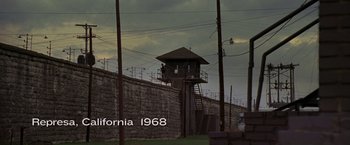 Movie still from “Walk the Line” (2005), directed by James Mangold – A tower with a ladder on top of it next to a wall; Extreme Wide shot, High angle