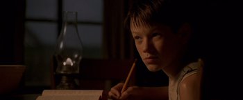 Movie still from “Walk the Line” (2005), directed by James Mangold – A young boy is writing with a pencil; Close Up shot, Over the shoulder angle