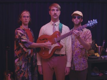 Movie still from “Colectivo Da Silva - Marina d’Or” (2019), directed by Kirkpatrick Buffet – Medium shot, Low angle