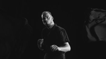 Movie still from “De Staat - Tie Me Down feat. Luwten” (2019), directed by Ruben Van Leer – Medium shot, Low angle