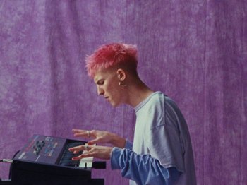 Movie still from “Gus Dapperton - Fill Me Up Anthem” (2019), directed by Gus Dapperton – Medium shot, High angle