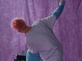 Movie still from “Gus Dapperton - Fill Me Up Anthem” (2019), directed by Gus Dapperton – Medium shot, Low angle