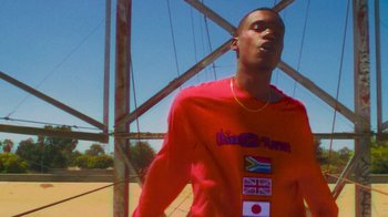 Movie still from “Huey Briss - Regardless” (2019), directed by Michael Priestley – Medium shot, Low angle