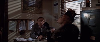 Movie still from “Chinatown” (1974), directed by Roman Polanski – A man and a woman sitting at a table; Medium shot, Over the shoulder angle