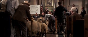 Movie still from “Chinatown” (1974), directed by Roman Polanski – A group of people standing around a group of sheep; Wide shot, Low angle