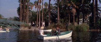 Movie still from “Chinatown” (1974), directed by Roman Polanski – A man and a woman are in a boat in the water; Wide shot, High angle