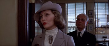Movie still from “Chinatown” (1974), directed by Roman Polanski – A woman wearing a hat and a suit; Close Up shot, Low angle