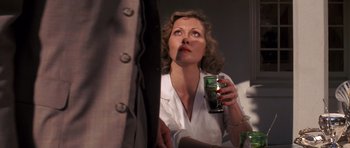 Movie still from “Chinatown” (1974), directed by Roman Polanski – A woman is holding a can of beer up to her face; Close Up shot, Low angle