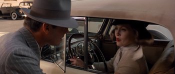 Movie still from “Chinatown” (1974), directed by Roman Polanski – A man and a woman sitting in the drivers seat of a car; Close Up shot, Over the shoulder angle
