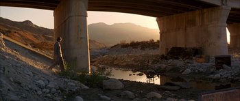 Movie still from “Chinatown” (1974), directed by Roman Polanski – A view from under an overpass looking out at mountains; Extreme Wide shot, High angle