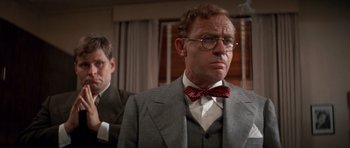 Movie still from “Chinatown” (1974), directed by Roman Polanski – A man in a suit and a bow tie; Close Up shot, Low angle