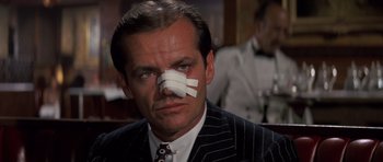 Movie still from “Chinatown” (1974), directed by Roman Polanski – A man with a bandage on his nose; Close Up shot, Low angle