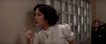 Movie still from “Chinatown” (1974), directed by Roman Polanski – A woman in a white dress standing in front of a wall; Close Up shot, Low angle