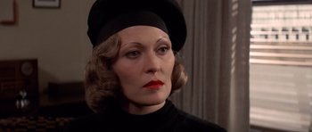 Movie still from “Chinatown” (1974), directed by Roman Polanski – A person wearing a hat; Close Up shot, Over the shoulder angle