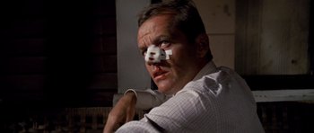 Movie still from “Chinatown” (1974), directed by Roman Polanski – A man with a bandage on his face; Close Up shot, Low angle