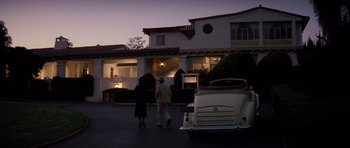 Movie still from “Chinatown” (1974), directed by Roman Polanski – A couple of people standing in front of a car; Extreme Wide shot, Low angle