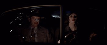 Movie still from “Chinatown” (1974), directed by Roman Polanski – A man and a woman sitting in a car at night; Close Up shot, Over the shoulder angle