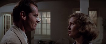 Movie still from “Chinatown” (1974), directed by Roman Polanski – A man and a woman looking at each other; Close Up shot, Over the shoulder angle