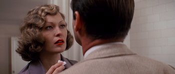 Movie still from “Chinatown” (1974), directed by Roman Polanski – A woman looking at a man in the mirror; Close Up shot, Over the shoulder angle