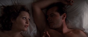 Movie still from “Chinatown” (1974), directed by Roman Polanski – A man and a woman laying in a bed together; Close Up shot, Overhead angle