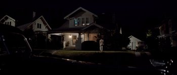 Movie still from “Chinatown” (1974), directed by Roman Polanski – A person standing in front of a house at night; Extreme Wide shot, Low angle