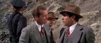 Movie still from “Chinatown” (1974), directed by Roman Polanski – A group of men standing next to each other on top of a hill; Close Up shot, Over the shoulder angle