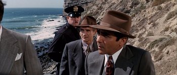Movie still from “Chinatown” (1974), directed by Roman Polanski – A group of men standing next to each other on top of a hill; Medium shot, High angle