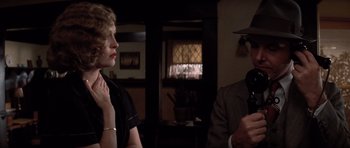 Movie still from “Chinatown” (1974), directed by Roman Polanski – A man and a woman are talking in a living room; Close Up shot, Over the shoulder angle