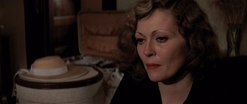 Movie still from “Chinatown” (1974), directed by Roman Polanski – A person sitting down with her eyes closed; Close Up shot, High angle
