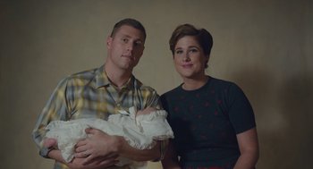 Movie still from “Wildlife” (2018), directed by Paul Dano – A man and a woman holding a newborn baby; Medium shot, Low angle