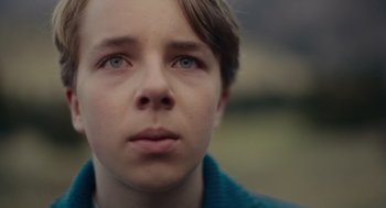 Movie still from “Wildlife” (2018), directed by Paul Dano – A person looking at the camera; Close Up shot, Low angle