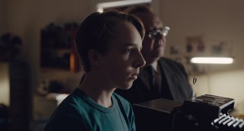 Movie still from “Wildlife” (2018), directed by Paul Dano – A young boy sitting in front of an older man; Close Up shot, Over the shoulder angle